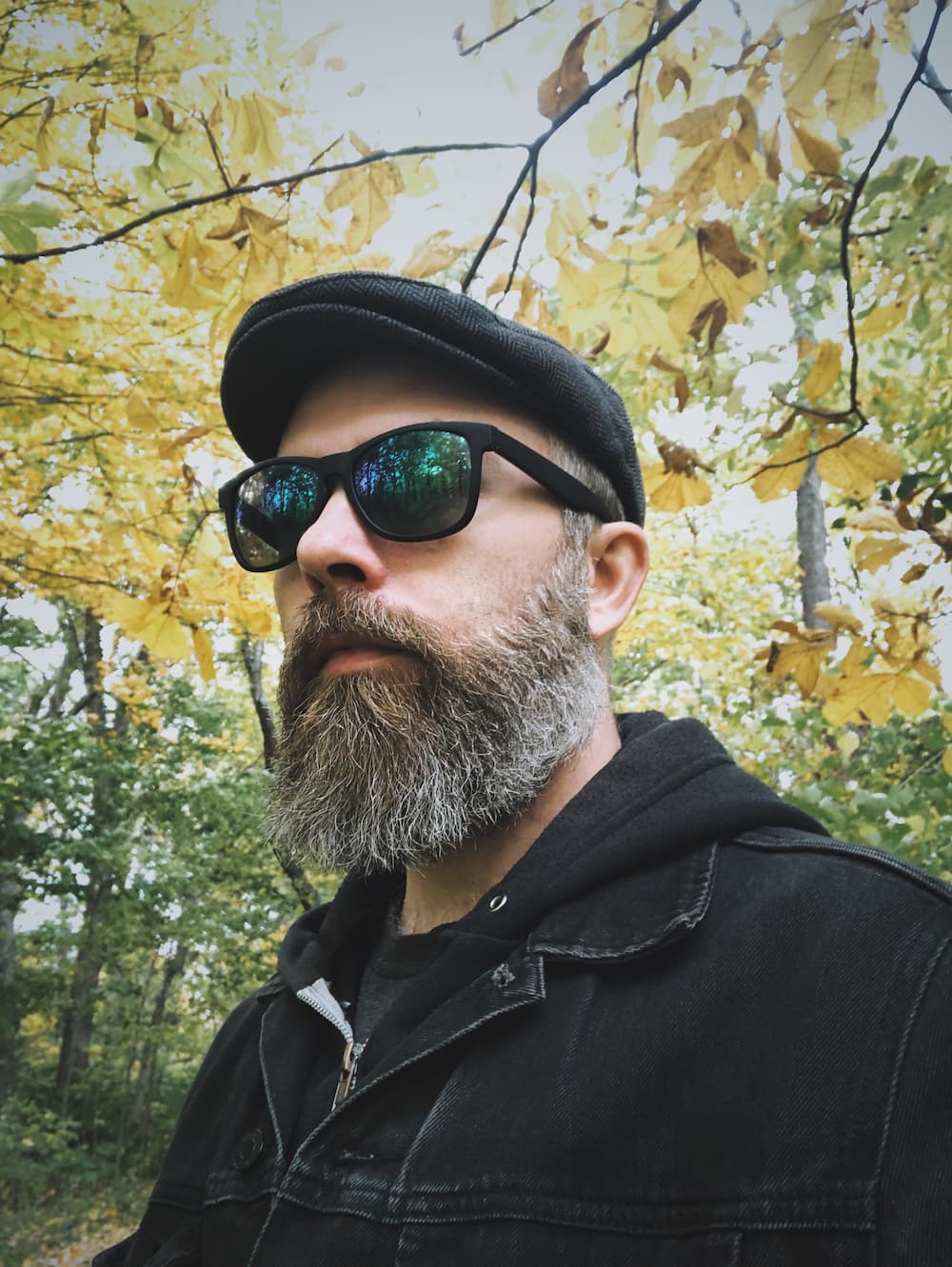 Jeff Finley amidst green and yellow leaves